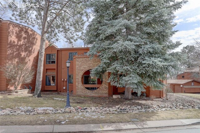 view of front of property featuring brick siding