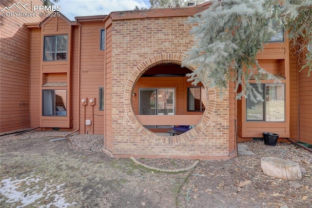 exterior space featuring brick siding