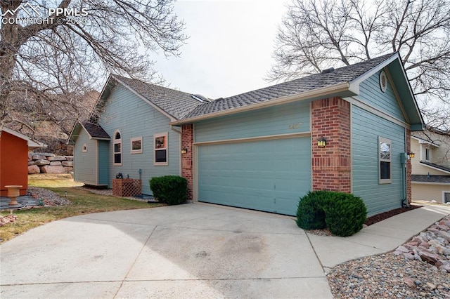 view of side of home with brick siding, concrete driveway, and a garage