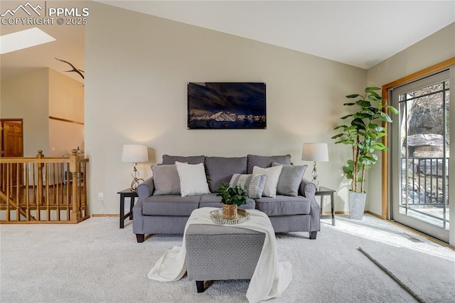 carpeted living room with baseboards and vaulted ceiling