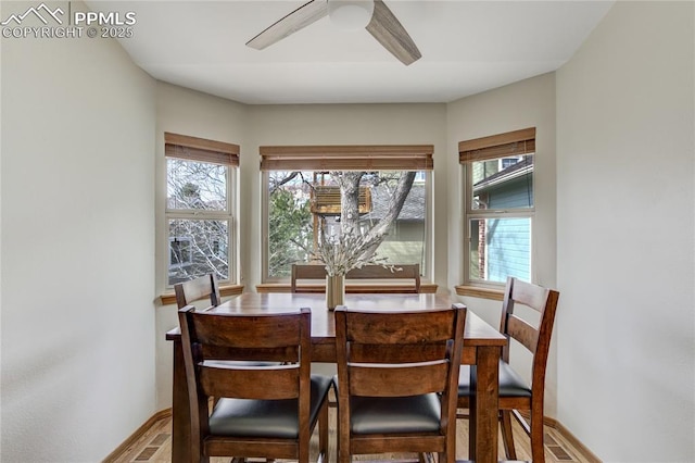 dining area with baseboards and ceiling fan