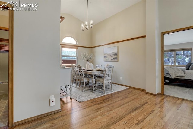 dining area with wood finished floors, a chandelier, and a wealth of natural light
