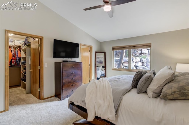 bedroom with a closet, a ceiling fan, light carpet, lofted ceiling, and a spacious closet