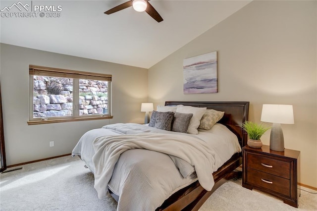 bedroom featuring light carpet, baseboards, lofted ceiling, and visible vents
