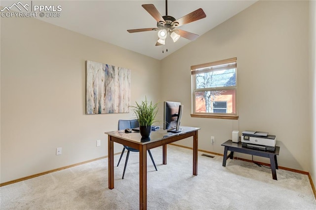 office area with baseboards, ceiling fan, vaulted ceiling, and light colored carpet