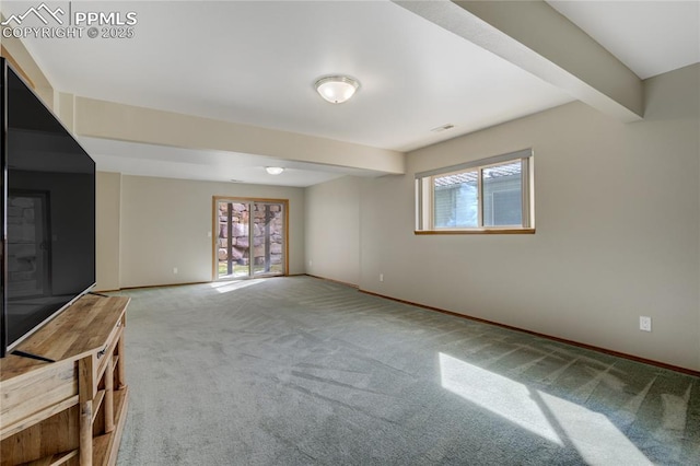 unfurnished living room with baseboards, visible vents, beamed ceiling, and light colored carpet