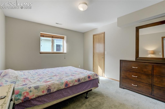 bedroom with visible vents and carpet flooring