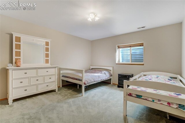 bedroom with light colored carpet and visible vents