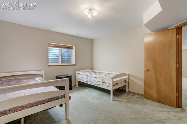 carpeted bedroom featuring baseboards