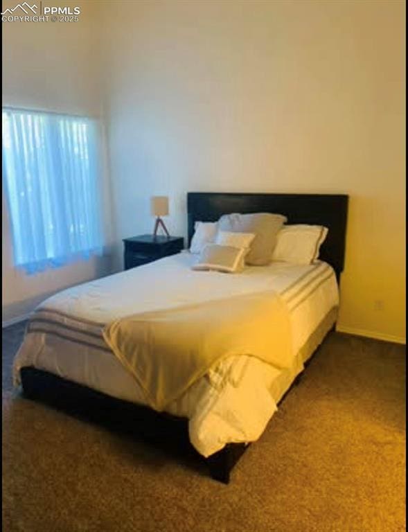 bedroom with baseboards and carpet flooring