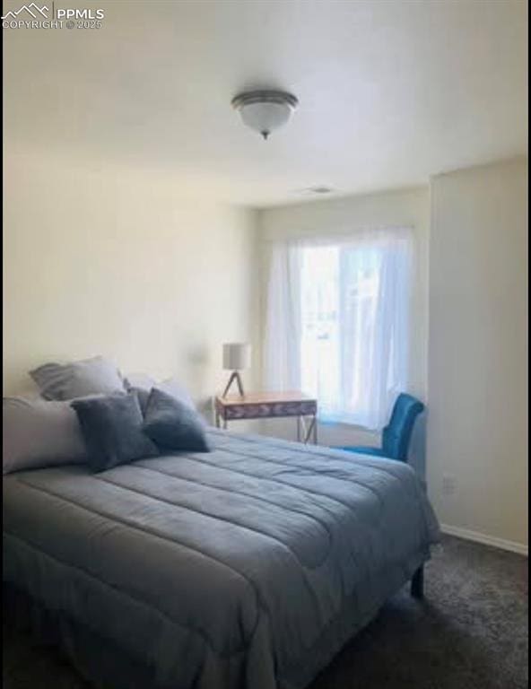 carpeted bedroom featuring baseboards