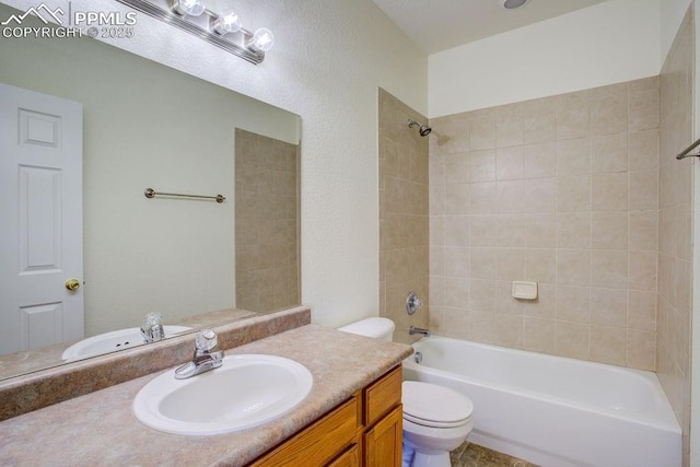 bathroom with vanity, toilet, and shower / bathtub combination