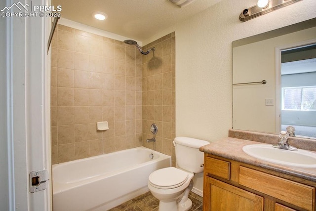 full bath featuring shower / bath combination, toilet, vanity, and tile patterned flooring