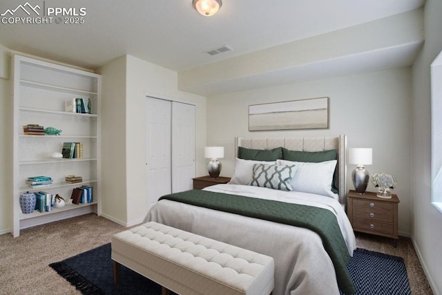 bedroom featuring carpet, visible vents, a closet, and baseboards