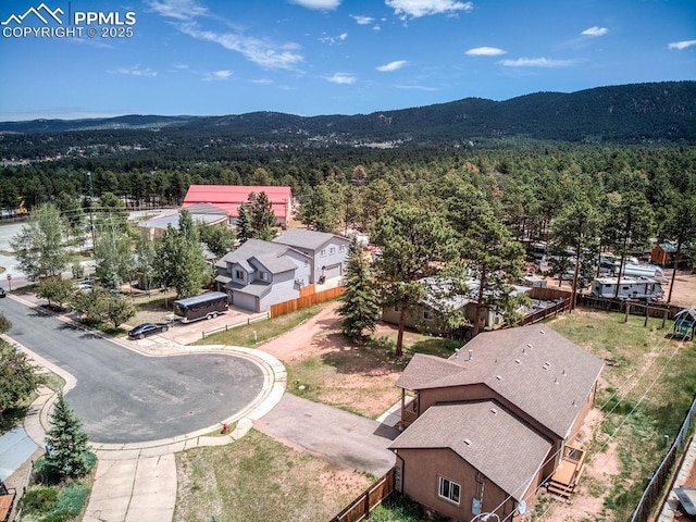 aerial view with a mountain view and a wooded view