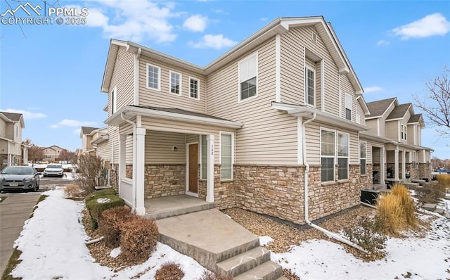 view of front of house with stone siding and a porch