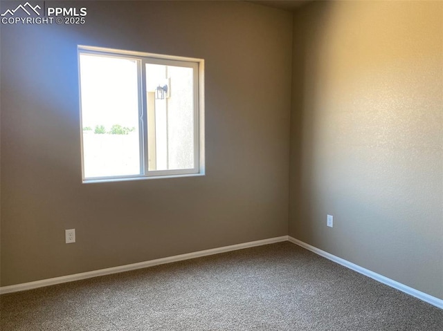 unfurnished room featuring baseboards and carpet flooring