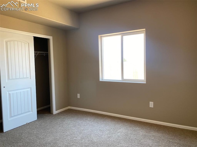 unfurnished bedroom with baseboards, a closet, and carpet floors