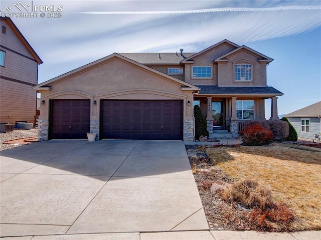 craftsman house featuring stucco siding, stone siding, a garage, and driveway