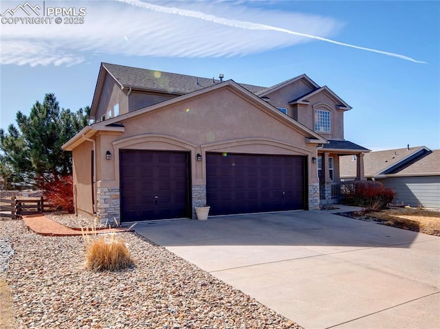 view of front facade featuring fence, stucco siding, driveway, stone siding, and an attached garage