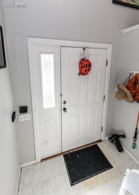 foyer featuring tile patterned floors and baseboards