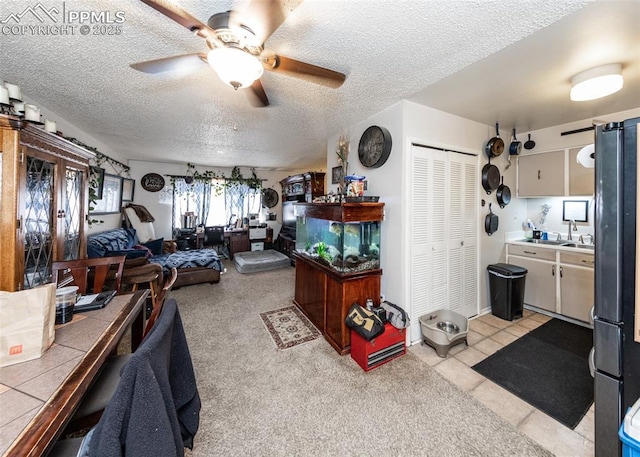 living room with a textured ceiling and a ceiling fan