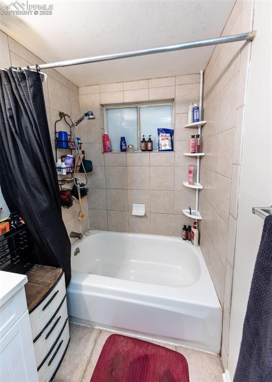 full bath with vanity and shower / bath combo with shower curtain