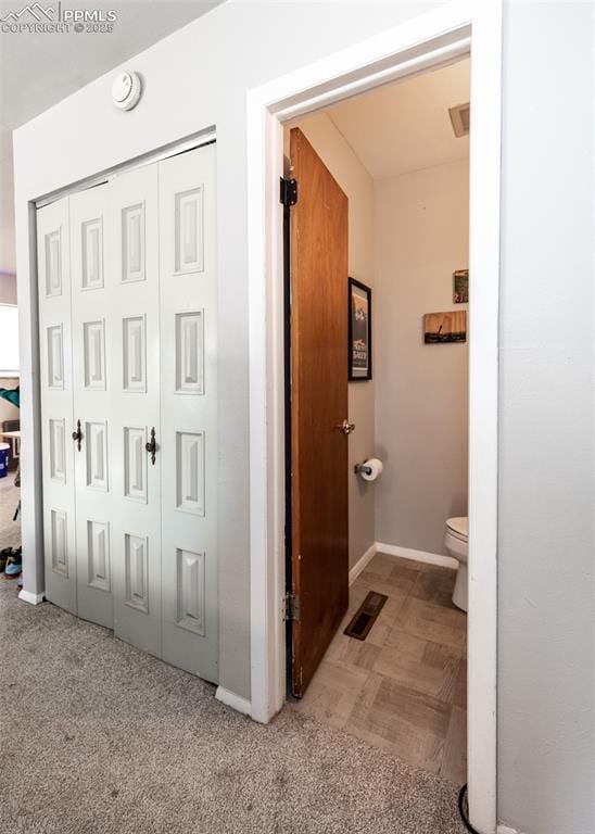 bathroom with visible vents, baseboards, and toilet