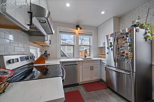 kitchen with decorative backsplash, recessed lighting, white cabinets, stainless steel appliances, and a sink