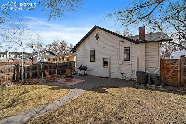 back of property with a yard, fence private yard, and a patio