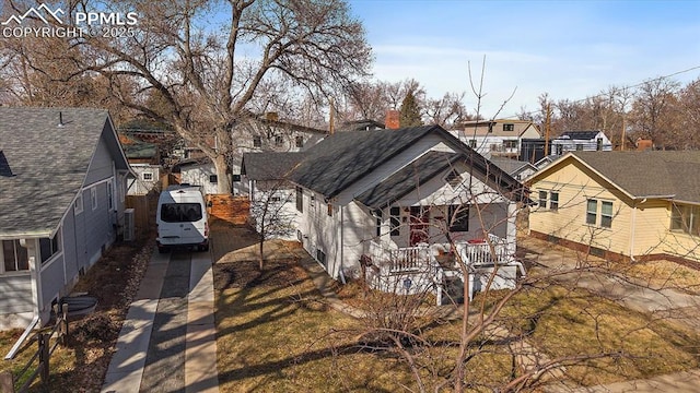 exterior space featuring a residential view, roof with shingles, and a porch