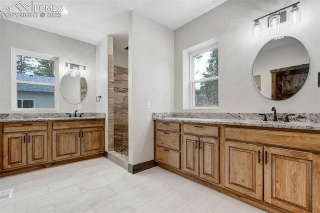 1309 Stone Ridge Dr, Woodland Park, CO 80863 - full bath with vanity, a wealth of natural light, and tiled shower