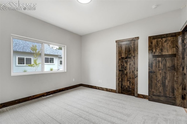 1309 Stone Ridge Dr, Woodland Park, CO 80863 - spare room featuring visible vents, carpet, and baseboards