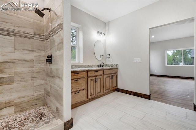 1309 Stone Ridge Dr, Woodland Park, CO 80863 - bathroom with vanity, baseboards, and a tile shower