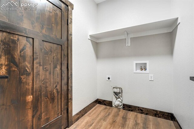 1309 Stone Ridge Dr, Woodland Park, CO 80863 - laundry area with wood finished floors, baseboards, laundry area, electric dryer hookup, and washer hookup