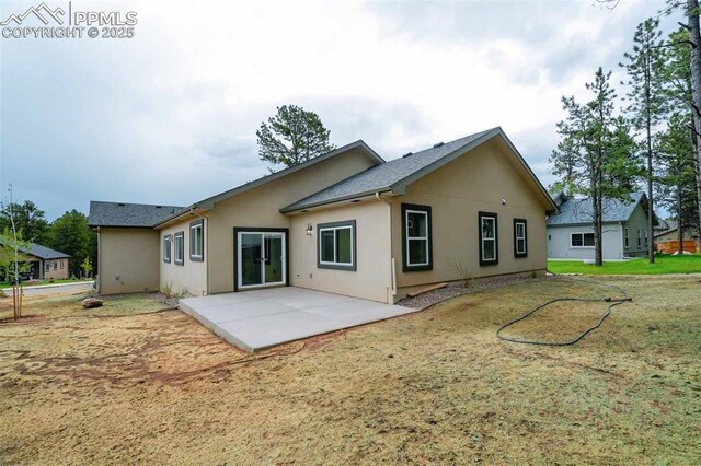 1309 Stone Ridge Dr, Woodland Park, CO 80863 - back of property featuring a patio and stucco siding