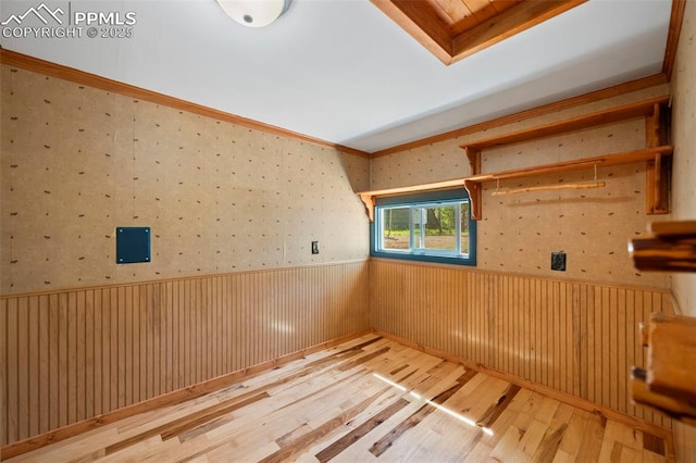 987 Blossom Rd, Woodland Park, CO 80863 - spare room with wallpapered walls, crown molding, wood finished floors, and a wainscoted wall