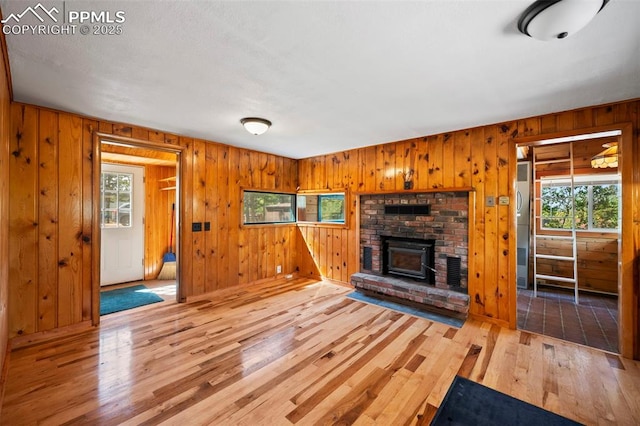 987 Blossom Rd, Woodland Park, CO 80863 - unfurnished living room featuring wooden walls and wood-type flooring