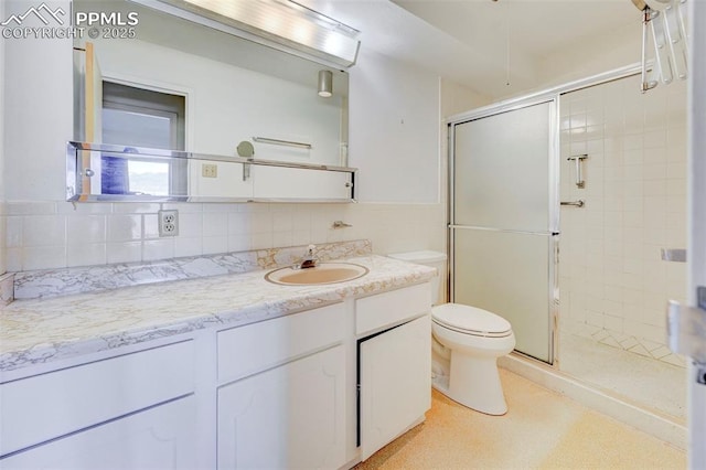 bathroom with backsplash, a shower stall, toilet, and vanity