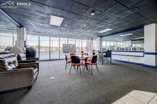 carpeted dining space with baseboards