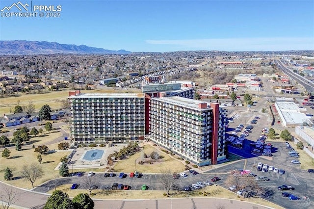 birds eye view of property with a view of city and a mountain view