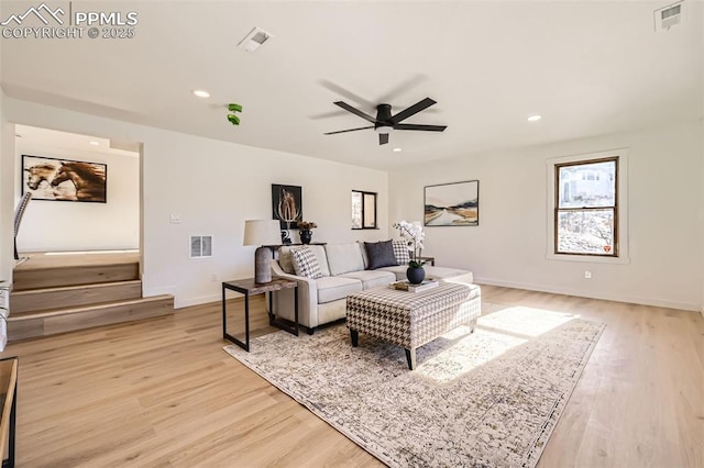 living room featuring recessed lighting, visible vents, and light wood finished floors