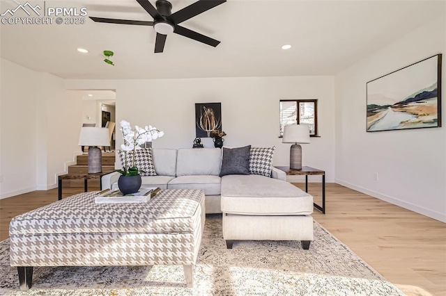 living area featuring a ceiling fan, recessed lighting, baseboards, and light wood finished floors