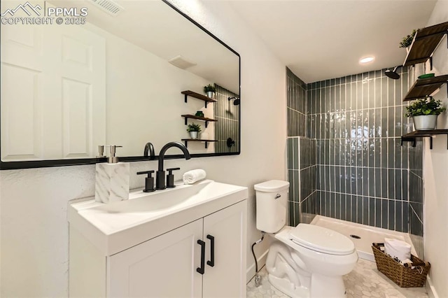 full bathroom featuring tiled shower, toilet, vanity, and visible vents