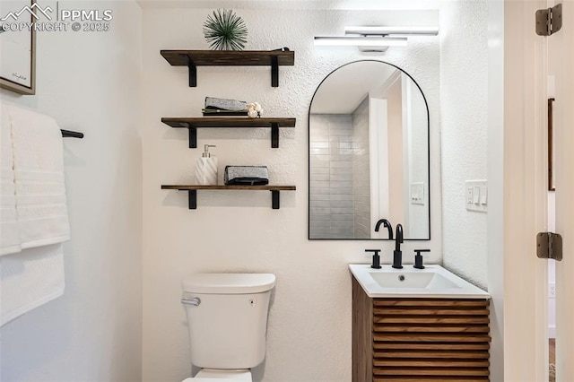 bathroom with toilet and vanity