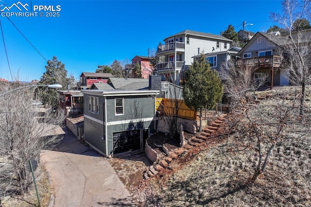 view of side of property with an attached garage and driveway