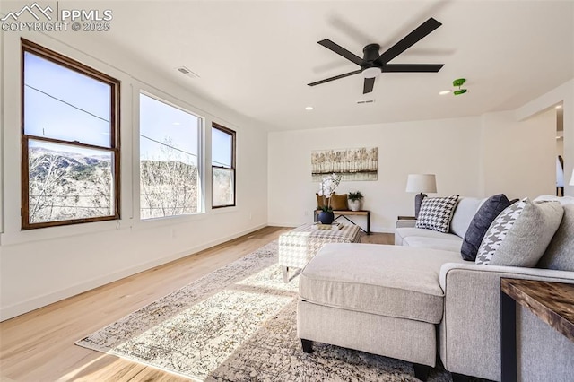 living room with visible vents, ceiling fan, baseboards, recessed lighting, and wood finished floors