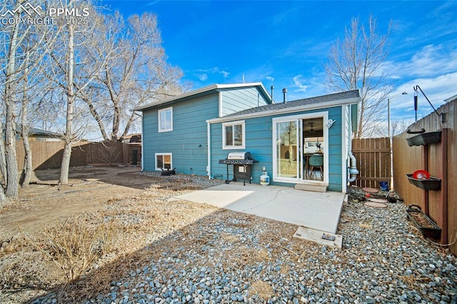 rear view of property with a patio and a fenced backyard