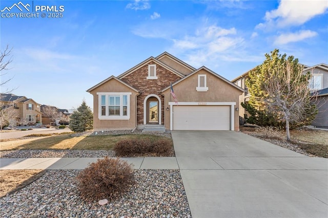 traditional home featuring stone siding, stucco siding, an attached garage, and concrete driveway