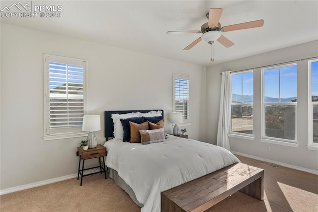 bedroom featuring baseboards, light carpet, visible vents, and a ceiling fan